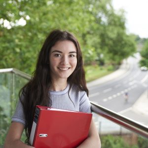Student Holding a Red Folder